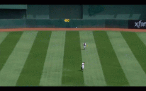 a baseball player with the number 8 on his back is sliding into base