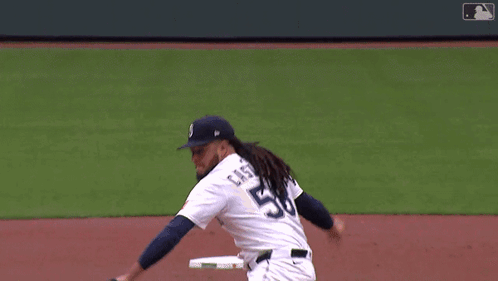 A Baseball Player With The Number 8 On The Back Of His Jersey Swings At A Pitch GIF