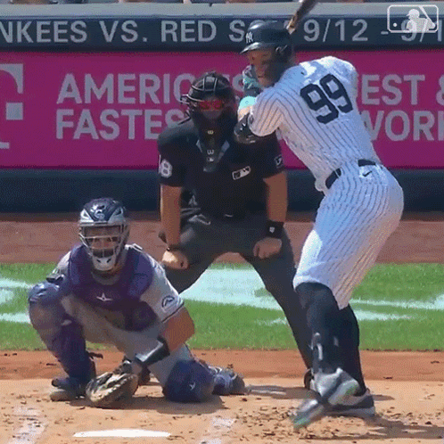 A Baseball Player With The Number 99 On His Jersey Is Swinging His Bat GIF