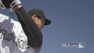 A Baseball Player With The Word Rockies On His Jersey Throws A Ball GIF