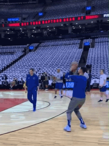 A Basketball Court With A Sign That Says " Get Your Raptors Bear At " GIF