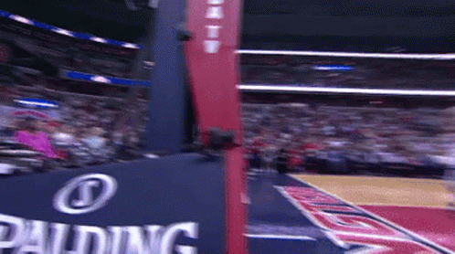 A Basketball Court With A Spalding Sign On It GIF