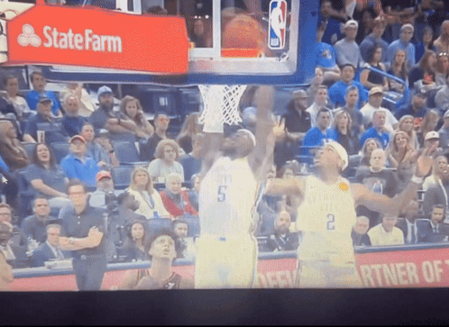 A Basketball Game Being Played In Front Of A State Farm Sign GIF