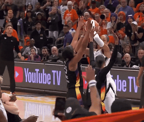 A Basketball Game Being Played In Front Of A Youtube Tv Banner GIF