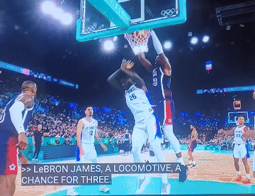 A Basketball Game Is Being Played And Lebron James Is Dunking GIF