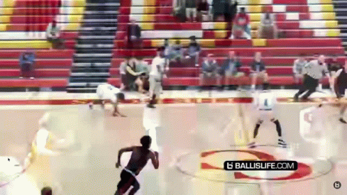 A Basketball Game Is Being Played In A Gym With A Ballislife.com Logo On The Court GIF
