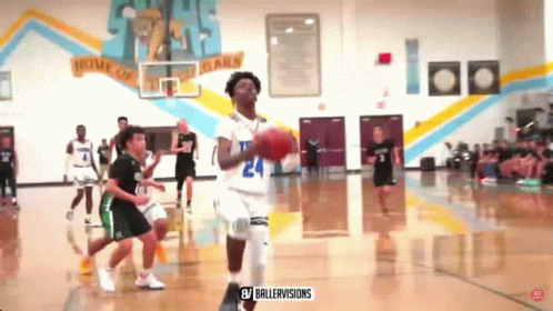 A Basketball Game Is Being Played In A Gym With A Banner On The Wall That Says Home Of The Bears GIF
