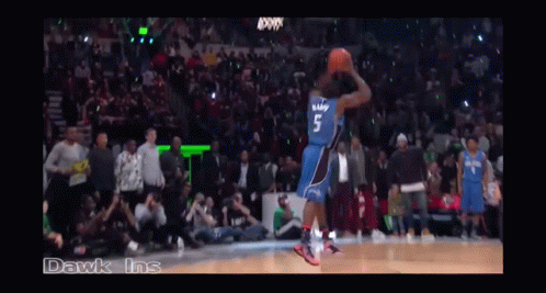 A Basketball Game Is Being Played In A Stadium With A Crowd Watching GIF