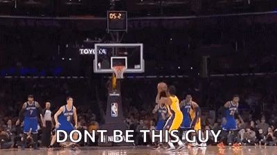 A Basketball Game Is Being Played In A Stadium With A Crowd Watching . GIF