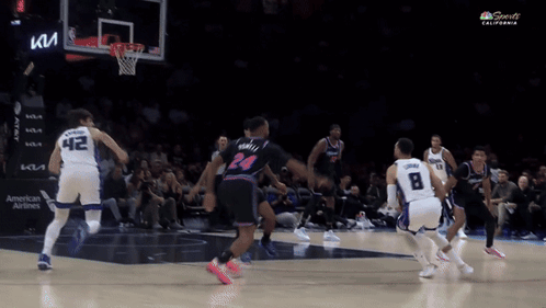 A Basketball Game Is Being Played In A Stadium With A Kia Sign In The Background GIF
