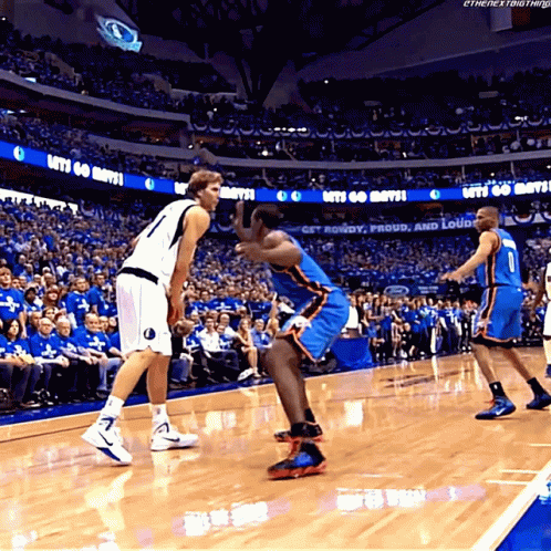 A Basketball Game Is Being Played In A Stadium With A Sign That Says Let 'S Go Mavs GIF