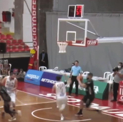 A Basketball Game Is Being Played In A Stadium With A Sign That Says " Netshoes " On It GIF