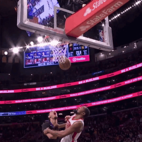 a basketball game is being played in a stadium with a state farm banner