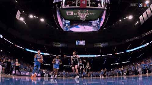 a basketball game is being played in a stadium with ads for state farm and mdf bank