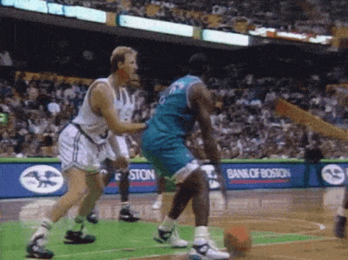 A Basketball Game Is Being Played In Front Of A Bank Of Boston Ad GIF