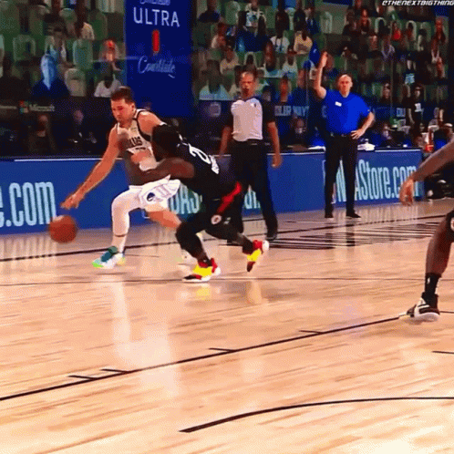 A Basketball Game Is Being Played In Front Of A Banner For Ultra GIF