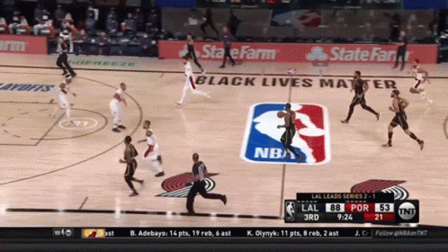 a basketball game is being played in front of a banner that says state farm