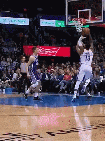 A Basketball Game Is Being Played In Front Of A Budweiser Advertisement GIF