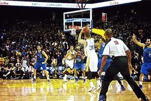 A Basketball Game Is Being Played In Front Of A Crowd And A Referee With The Number 39 On His Back GIF