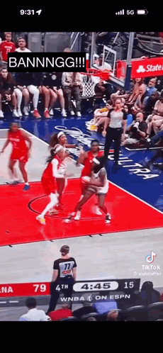 A Basketball Game Is Being Played In Front Of A Crowd Of People . GIF