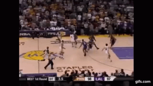 A Basketball Game Is Being Played In Front Of A Crowd . GIF