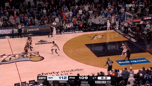 A Basketball Game Is Being Played In Front Of A Crowd Sponsored By Xfinity Mobile And Peacock GIF