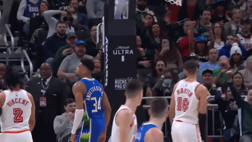 A Basketball Game Is Being Played In Front Of A Crowd That Is Cheering For The Bucks GIF