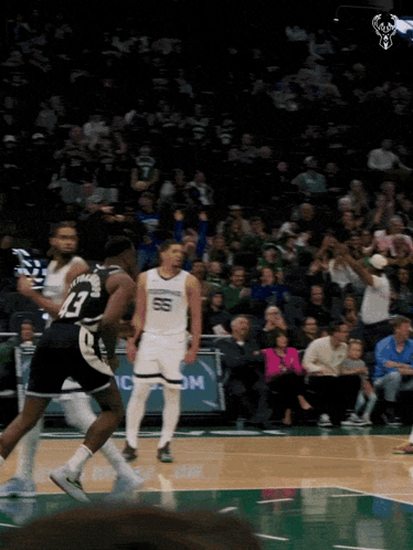 A Basketball Game Is Being Played In Front Of A Crowd That Is Watching GIF