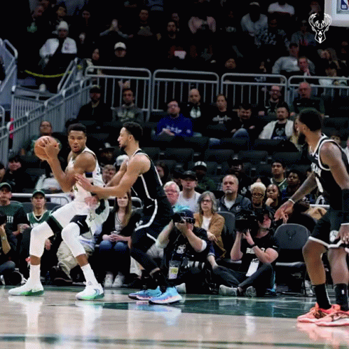 A Basketball Game Is Being Played In Front Of A Crowd With A Picture Of A Deer On The Scoreboard GIF