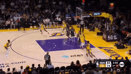 a basketball game is being played in front of a crowd with a scoreboard that says tnt on it