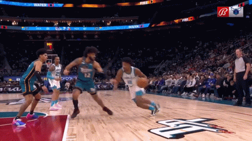 A Basketball Game Is Being Played In Front Of A Crowd With A Sign That Says Fire On It GIF