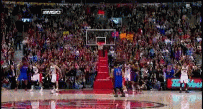 A Basketball Game Is Being Played In Front Of A Crowd With A Sign That Says #Msc On It GIF