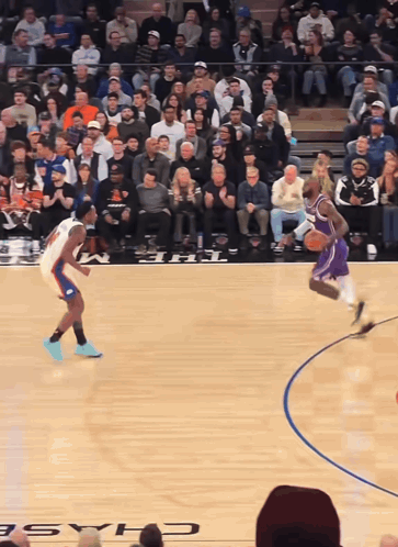 A Basketball Game Is Being Played In Front Of A Crowd With The Word Chase On The Court GIF