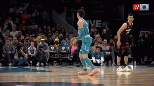 A Basketball Game Is Being Played In Front Of A Crowd With The Word Wave On The Stands GIF