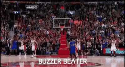 A Basketball Game Is Being Played In Front Of A Crowd With The Words Buzzer Beater Written On The Bottom . GIF