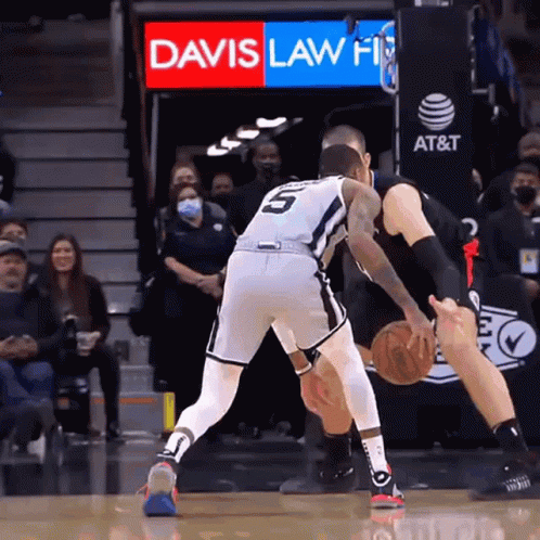 A Basketball Game Is Being Played In Front Of A Davis Law Firm Sign GIF