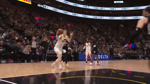 A Basketball Game Is Being Played In Front Of A Delta Advertisement GIF