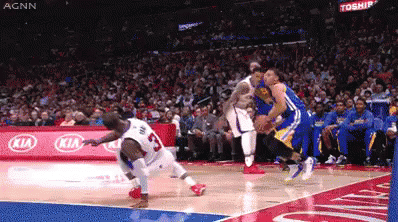 A Basketball Game Is Being Played In Front Of A Kia Sign GIF