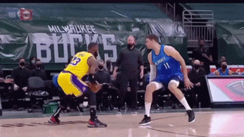 A Basketball Game Is Being Played In Front Of A Milwaukee Bucks Banner GIF