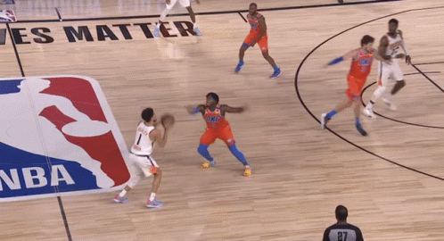 A Basketball Game Is Being Played In Front Of A Nba Logo GIF