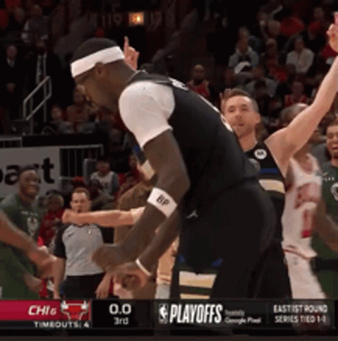A Basketball Game Is Being Played In Front Of A Playoffs Banner GIF