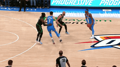 a basketball game is being played in front of a progressive program sign