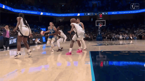 A Basketball Game Is Being Played In Front Of A Scoreboard That Says " Your Personal Financial Assistant " GIF