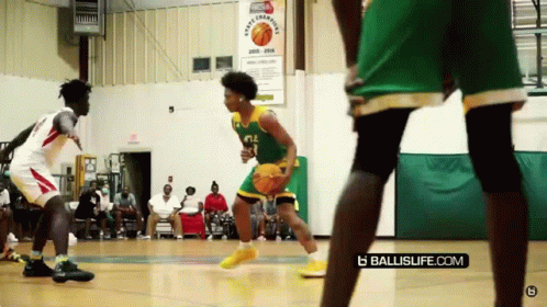 A Basketball Game Is Being Played In Front Of A Sign That Says Sports League GIF