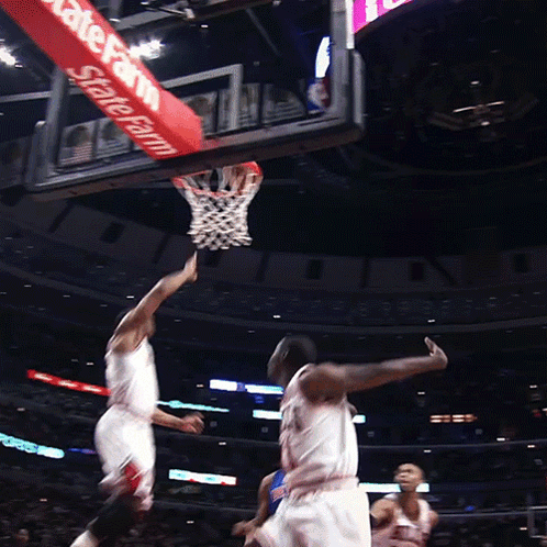 A Basketball Game Is Being Played In Front Of A Sign That Says State Farm GIF