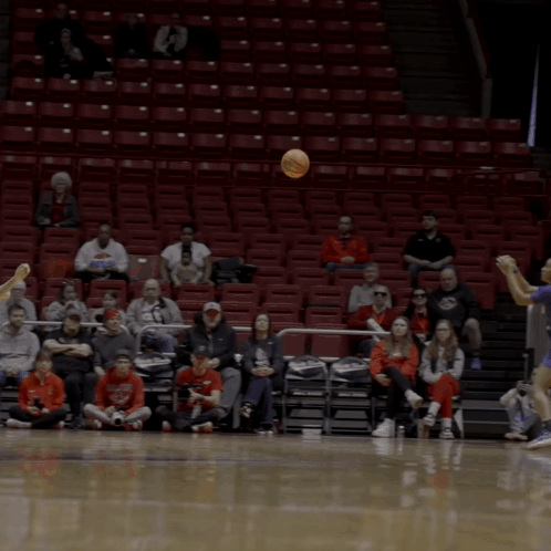 a basketball game is being played in front of a sign that says ' store ' on it
