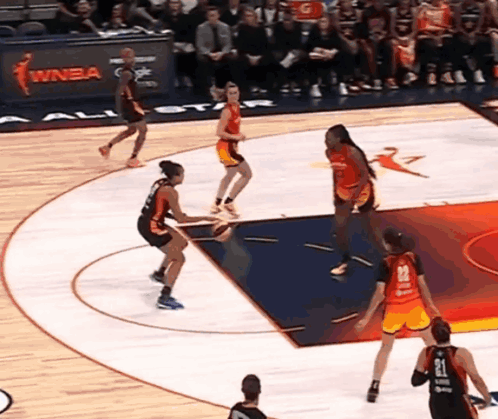 A Basketball Game Is Being Played In Front Of A Sign That Says Winba On It GIF