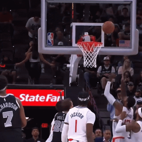 a basketball game is being played in front of a state farm ad