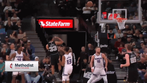 A Basketball Game Is Being Played In Front Of A State Farm Ad GIF