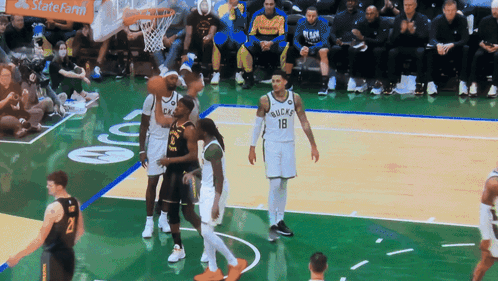 A Basketball Game Is Being Played In Front Of A Statefarm Banner GIF